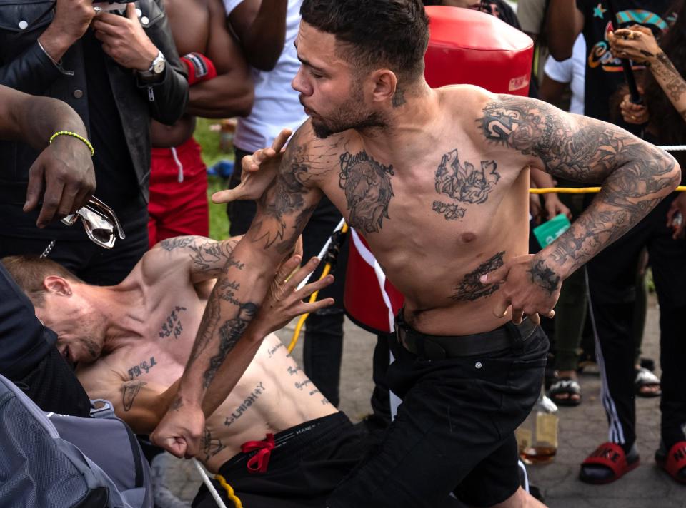 Austin Lajiness, left, of Detroit, and Jarid Jackson, right, of Wayne, settle their long-time beef with each other during a bare-knuckle fight at a Pick Your Poison Detroit event in Detroit's Delray neighborhood on Sunday, June 19, 2021. After the tense fight, the two finally shook hands and watched the rest of the matches without any issues.