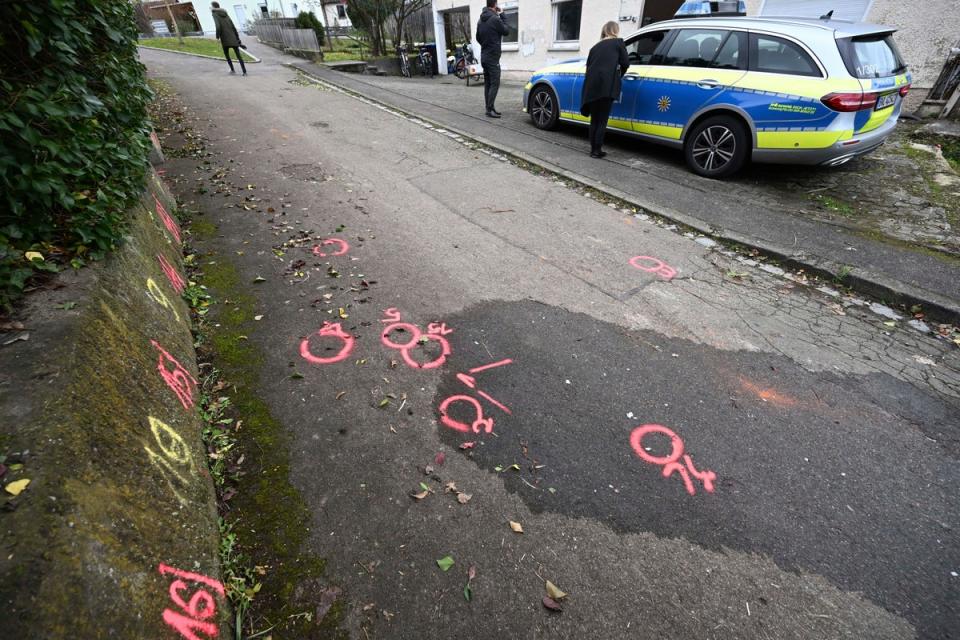 Police forensics markers are painted at a crime scene where two girls were attacked on their way to school in Illerkirchberg  (AP)