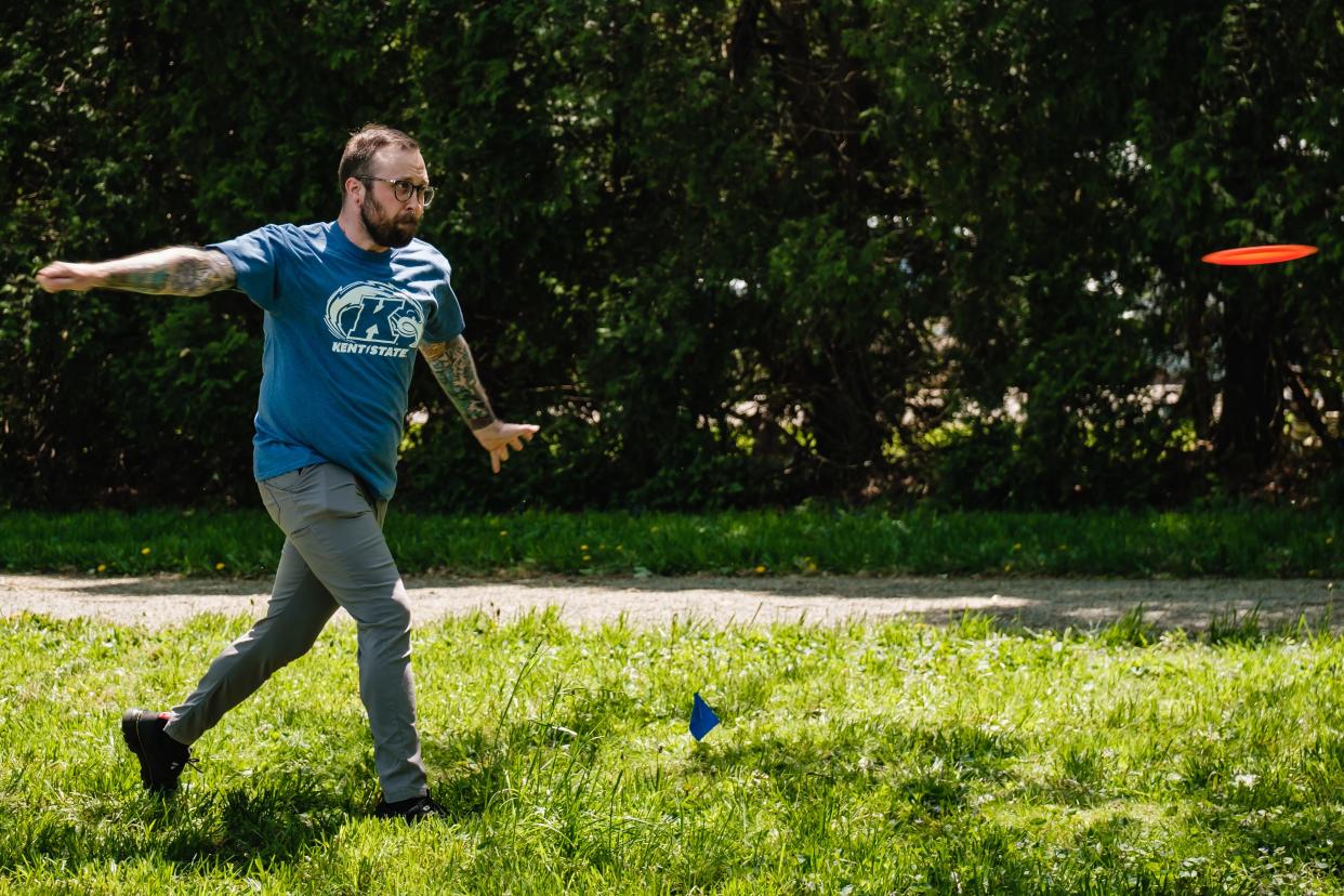 Kyle Schaar, a senior at Kent State University at Tuscarawas, plays the new disc golf course he designed at the New Philadelphia campus.