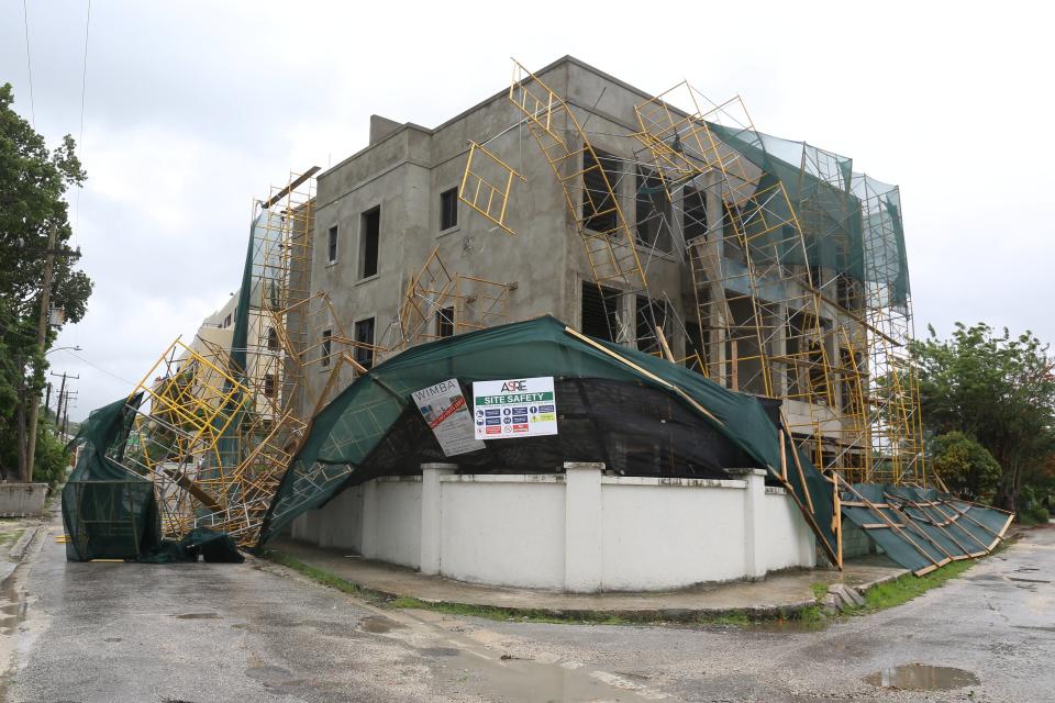 Collapsed scaffolding hangs off a building Bridgetown, Barbados after Hurricane Beryl blew through the island (REUTERS)