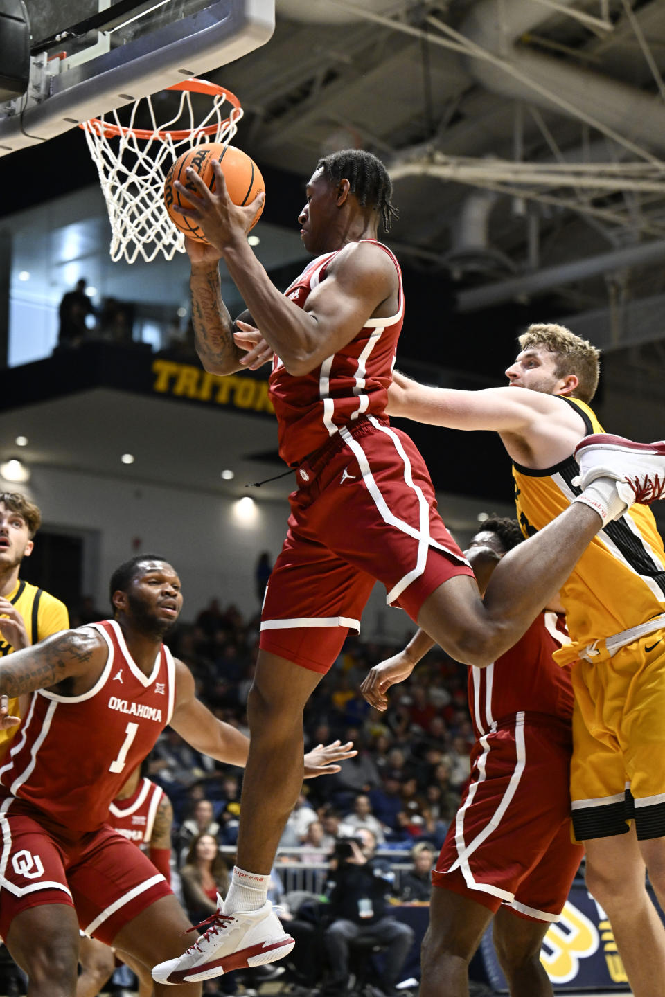 Oklahoma forward Jalon Moore (14) grabs a rebound during the first half of an NCAA college basketball game against Iowa Thursday, Nov. 23, 2023, in San Diego. (AP Photo/Denis Poroy)