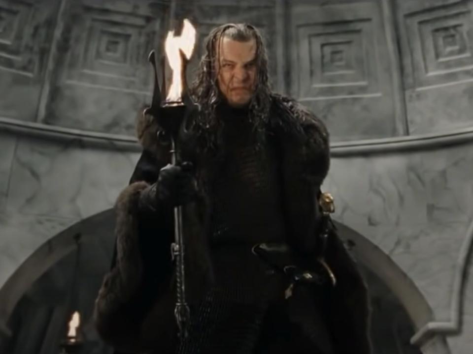 Denethor II holding a staff of fire in lord of the rings