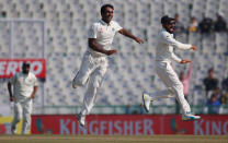 Cricket - India v England - Third Test cricket match - Punjab Cricket Association Stadium, Mohali, India - 26/11/16. India's captain Virat Kohali and Jayant Yadav (C) celebrates the dismissal of England's Joe Root. REUTERS/Adnan Abidi