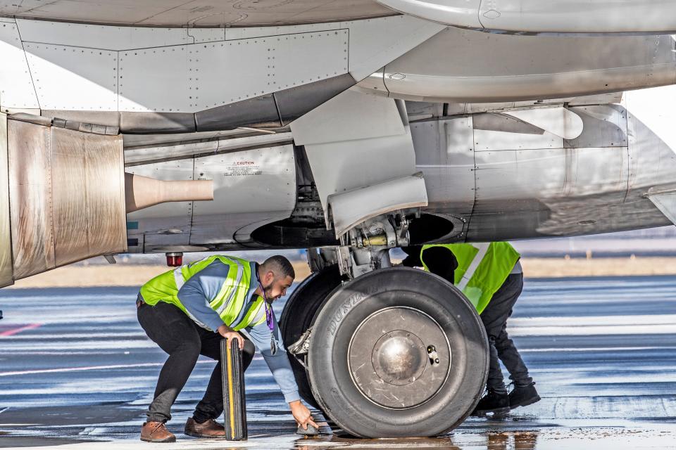 Airport personnel work to ready Avelo Airline's Boeing 737-700 for its first flight to Orlando, Fla., out of New Castle Airport near New Castle, Wednesday, Feb. 1, 2023.