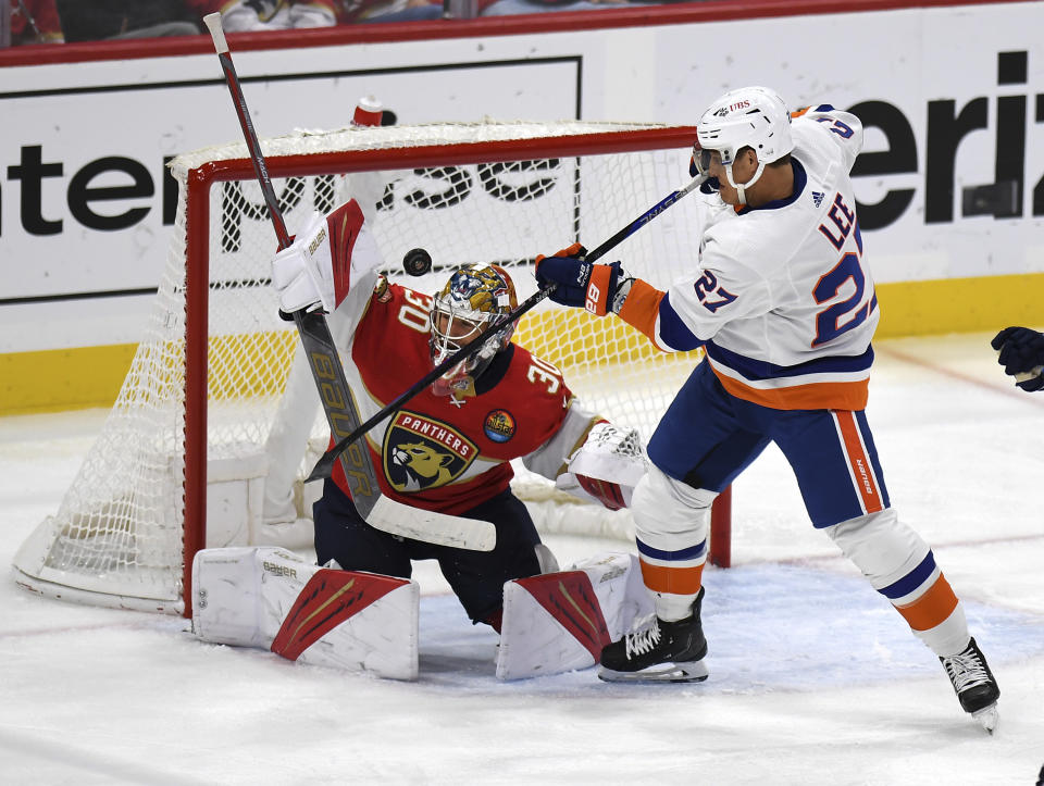 New York Islanders' Anders Lee (27) scores a goal against Florida Panthers goalie Spencer Knight, left, during the second period of an NHL hockey game, Sunday, Oct. 23, 2022, in Sunrise, Fla. (AP Photo/Michael Laughlin)