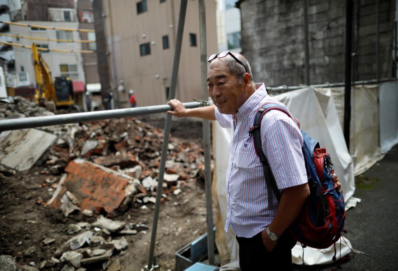 Fumiaki Ichiyama who managed Yonosuke that closed the business this spring, watches the site where his bar was located amid the coronavirus disease (COVID-19) outbreak, in Tokyo