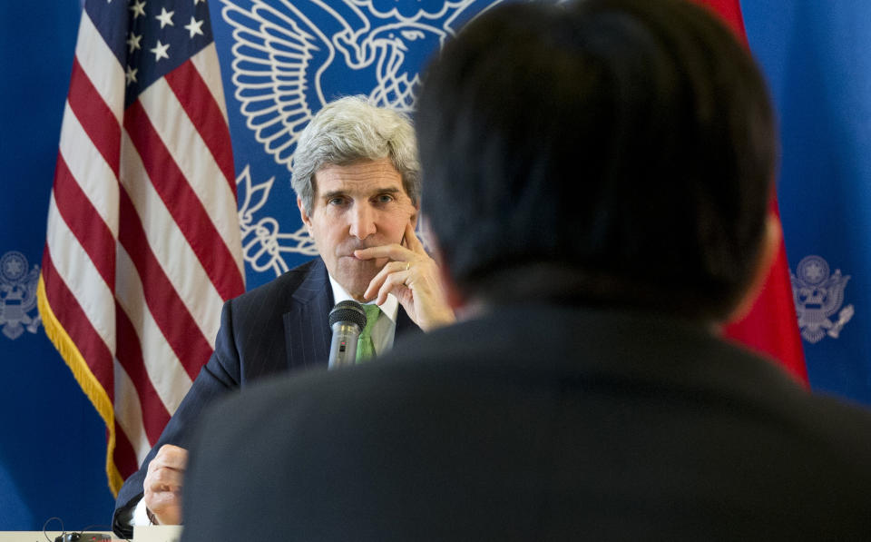 U.S. Secretary of State John Kerry, rear, listens to a question during a discussion with Chinese bloggers on a number of issues, including internet freedom, Chinese territorial disputes with Japan, North Korea, and human rights, on Saturday, Feb. 15, 2014, in Beijing, China. (AP Photo/Evan Vucci, Pool)