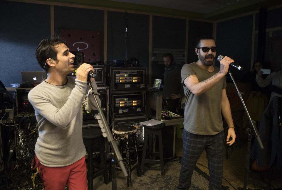 In this Monday, Feb. 27, 2017 photo, Iranian Shahin Najafi, right, and Israeli Aviv Geffen singers rehearse in Tel Aviv, Israel. In a first joint Israeli-Iranian concert, the rockers hope to prove that despite the bitter enmity between their countries the people can unite in the name of a better future. Geffen and Najafi say their Hebrew-Farsi fusion offers hope in a volatile region. (AP Photo/Dan Balilty)