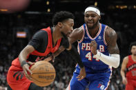 Toronto Raptors guard Kobi Simmons, left, tries to get the ball around Philadelphia 76ers forward Paul Reed (44) during the first half of an NBA basketball game in Toronto, Sunday, March 31, 2024. (Frank Gunn/The Canadian Press via AP)