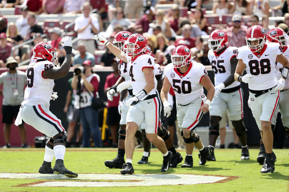 AP Top 25 No. 1 Georgia celebrates a touchdown reception by tight end Oscar Delp (4) during the second half of an NCAA college football game against South Carolina on Saturday, Sept. 17, 2022 in Columbia, S.C. (AP Photo/Artie Walker Jr.)