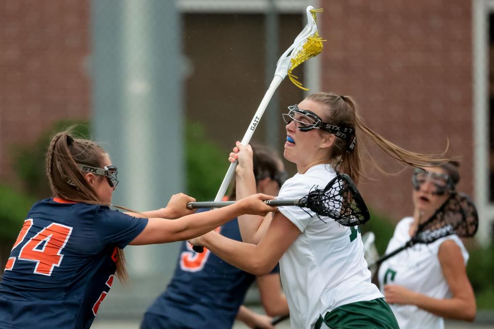 Olympus’s Addie Wride drives against Brighton’s Courtnie Wright in a 5A girls lacrosse semifinal game at Westminster College in Salt Lake City on Tuesday, May 23, 2023. | Spenser Heaps, Deseret News