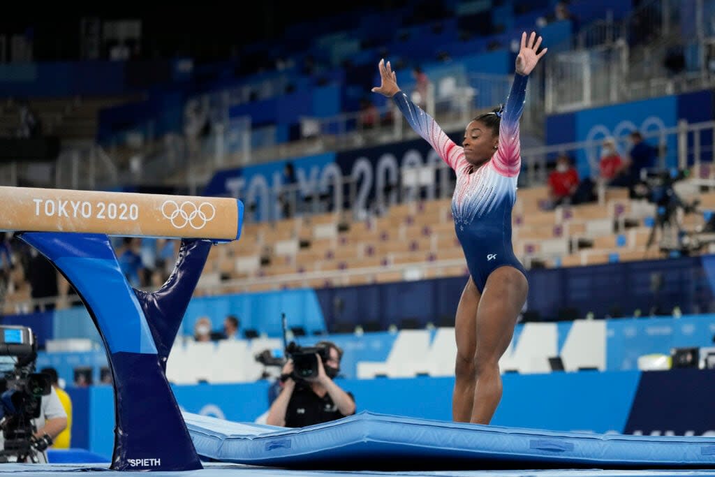 Simone Biles, of the United States, warms up prior to the artistic gymnastics balance beam final at the 2020 Summer Olympics, Tuesday, Aug. 3, 2021, in Tokyo, Japan. (AP Photo/Ashley Landis)