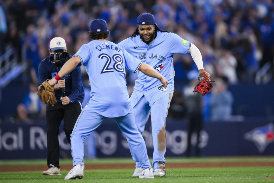 Toronto Blue Jays' Vladimir Guerrero Jr. (27) celebrates Ernie Clement (28) after defeating the Minnesota Twins in a baseball game, Saturday, May 11, 2024, in Toronto. (Chris Katsarov/The Canadian Press via AP)