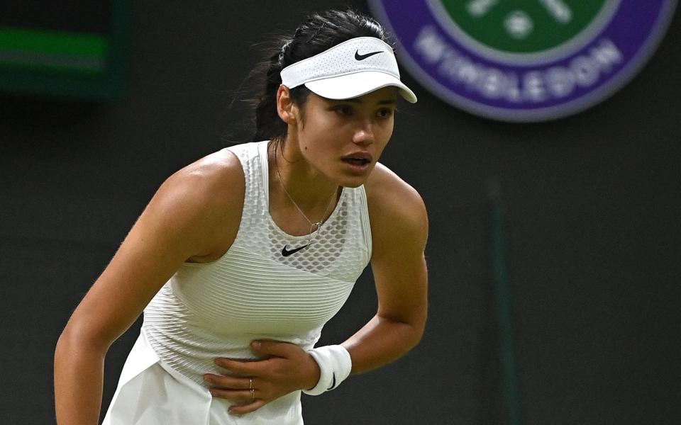 Emma Raducanu appeared to hold her stomach during the match - AFP