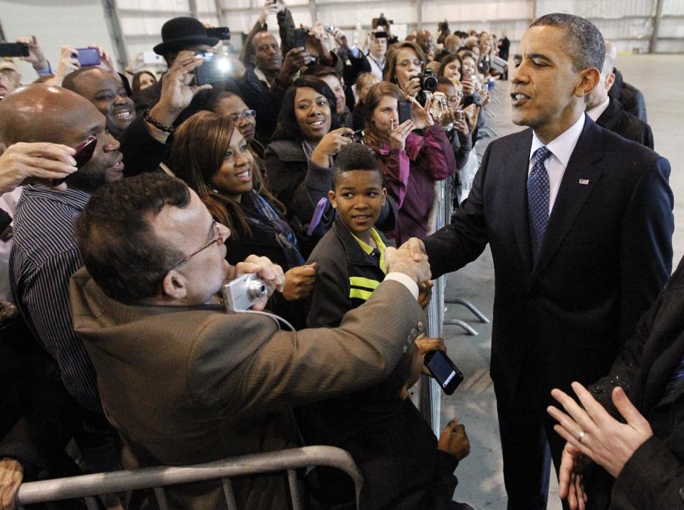 President Barack Obama greets supporters inside a hanger during his arrival at Ellington Airport, Friday, March, 9, 2012, in Houston. (AP Photo/Pablo Martinez Monsivais)