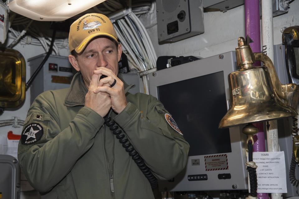 In this image provided by the U.S. Navy, Capt. Brett Crozier, then-commanding officer of the aircraft carrier USS Theodore Roosevelt (CVN 71), addresses the crew on Jan. 17, 2020, in San Diego, Calif. The Navy’s top admiral will soon decide the fate of the ship captain who was fired after pleading for his superiors to move faster to safeguard his coronavirus-infected crew on the USS Theodore Roosevelt. (Mass Communication Specialist Seaman Alexander Williams/U.S. Navy via AP)