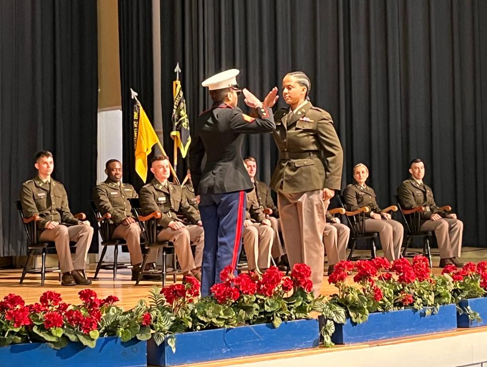 2nd Lt. Chantel Rosario de Los Santos, right, receives her first salute from Marine Sgt. Tracy Santos, president of the URI Student Veteran Organization. (Following tradition, Rosario de Los Santos gave Santos a silver dollar after the first salute.)