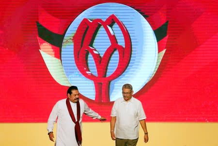 Sri Lanka's former defense secretary Gotabaya Rajapaksa shares a moment with his brother and former president Mahinda Rajapaksa after he was nominated as a presidential candidate during the Sri Lanka People's Front party convention in Colombo