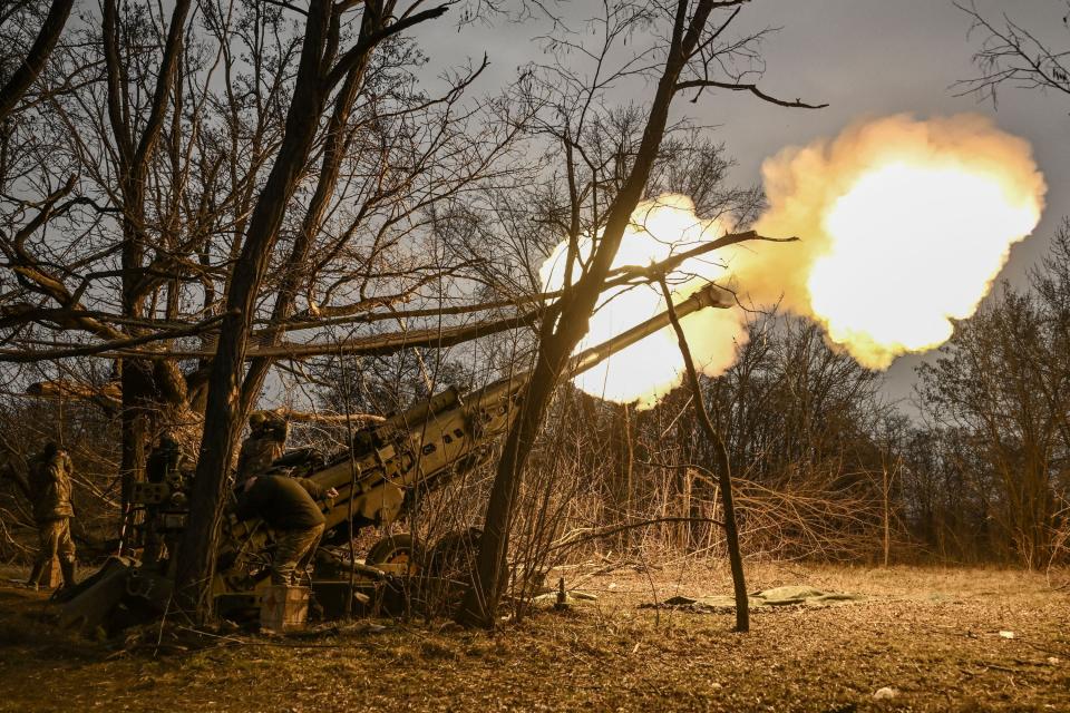 Ukrainian servicemen fire a M777 howitzer at Russian positions near Bakhmut, eastern Ukraine, on March 17, 2023.