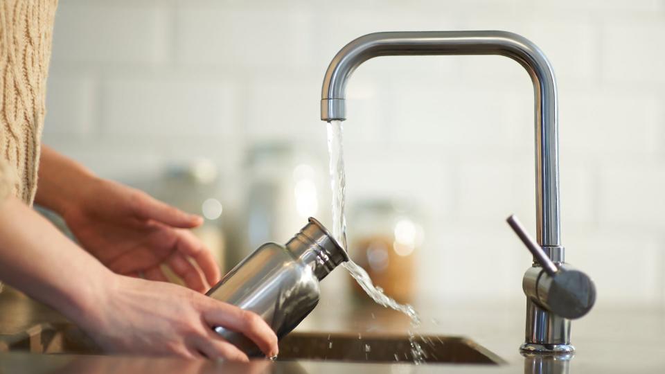 woman refilling water bottle