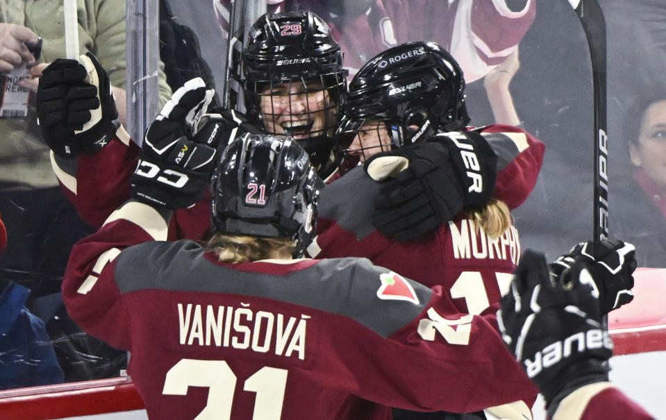 Montreal's Marie-Philip Poulin (29) celebrates her goal against New York with Tereza Vanisova (21) and Maureen Murphy during the third period of a PWHL hockey game Tuesday, Jan. 16, 2024, in Laval, Quebec. (Graham Hughes/The Canadian Press via AP)