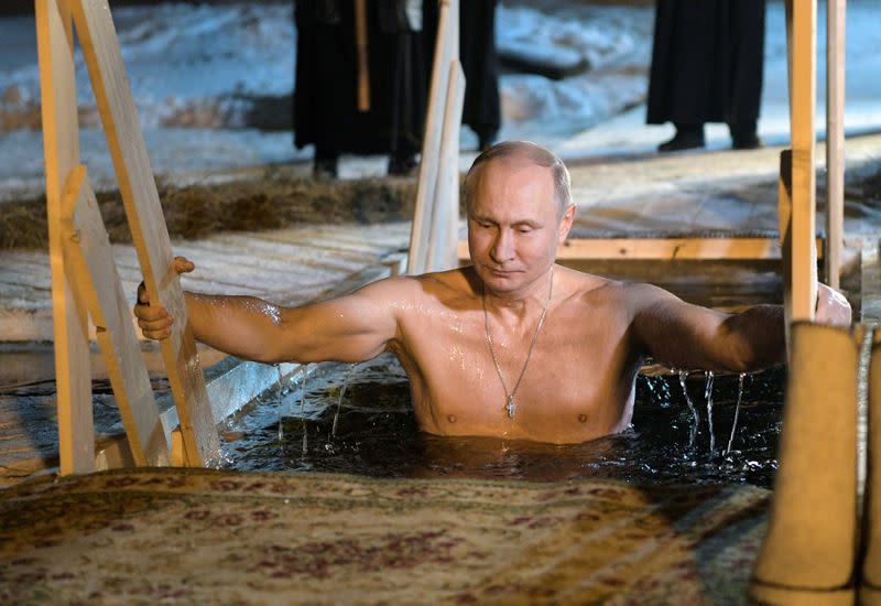 Russian President Vladimir Putin takes a dip in the water during Orthodox Epiphany celebrations at lake Seliger, Tver region