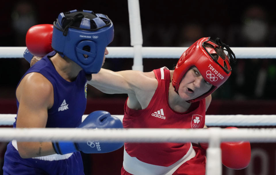 FILE - Brazil's Beatriz Ferreira, left, is punched by Ireland's Kellie Harrington during their women's light weight 57-60kg final boxing match at the 2020 Summer Olympics, Sunday, Aug. 8, 2021, in Tokyo, Japan. (AP Photo/Themba Hadebe, File)