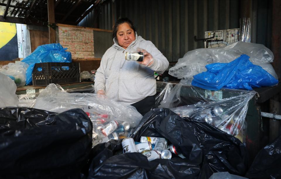 Josefa Marin, President the Alliance of Independent Recyclers, sorts a bag full of cans at Sure We Can, a non-profit recycling center, community space and sustainability hub in Brooklyn, photographed Nov. 16, 2023.