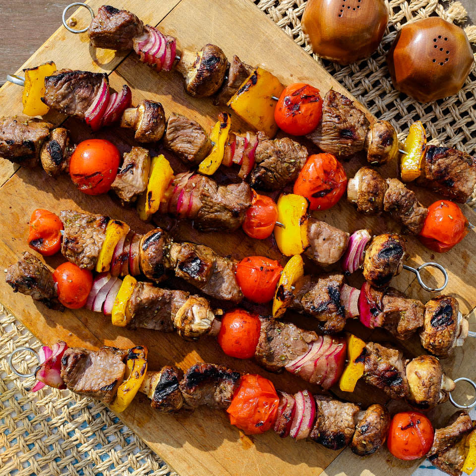 <p>These easy grilled beef & vegetable kebabs are not only delicious--they're economical too. Tri-tip is an inexpensive and flavorful cut of beef that takes beautifully to cooking over an open flame. Thread it onto skewers with colorful veggies and marinate for up to eight hours before cooking on the grill or over your campfire. Either way, it's a healthy and tasty summer meal. <a href="https://www.eatingwell.com/recipe/274659/grilled-beef-vegetable-kebabs/" rel="nofollow noopener" target="_blank" data-ylk="slk:View Recipe" class="link ">View Recipe</a></p>