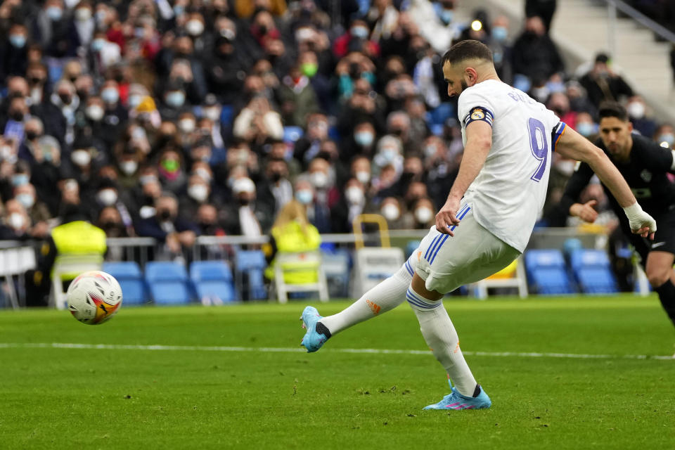Real Madrid's Karim Benzema shoots a penalty kick but fails to score during a Spanish La Liga soccer match between Real Madrid and Elche at the Bernabeu stadium in Madrid, Spain, Sunday, Jan. 23, 2022. (AP Photo/Manu Fernandez)