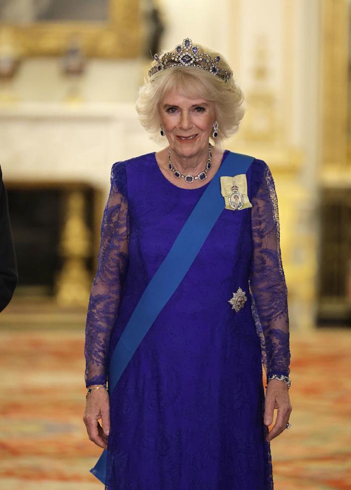 <p>Camilla, Queen Consort, wore a diamond and sapphire that belonged to Queen Elizabeth. She re-wore a blue Bruce Odfield dress that she wore earlier this year in Rwanda.</p>