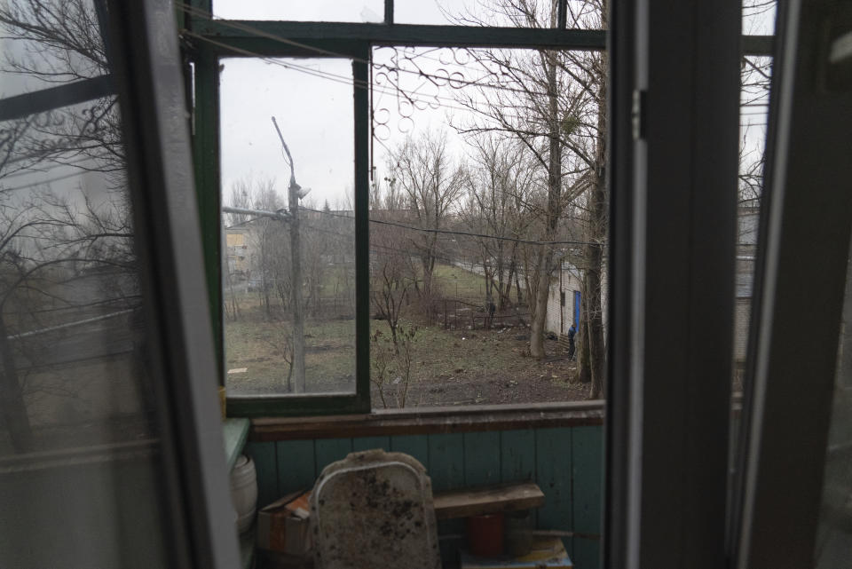 The landscape of the yard seen from Mykola's Soloviov apartment that was depicted in the painting shown by his wife, Sloviansk, a city in Donetsk region, his hometown which lies 25 kilometers from the frontline, Ukraine, Saturday, Jan. 27, 2024. Soloviov, 88, is a painter the world does not know. His expressive and imaginative landscapes of eastern Ukraine encapsulate a lost time, and lie undiscovered, tucked away in a modest home under threat of Russian attack. (AP Photo/Vasilisa Stepanenko)