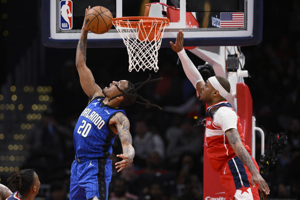 Orlando Magic guard Markelle Fultz (20) goes to the basket against Washington Wizards center Daniel Gafford during the first half of an NBA basketball game Friday, March 31, 2023, in Washington. (AP Photo/Nick Wass)