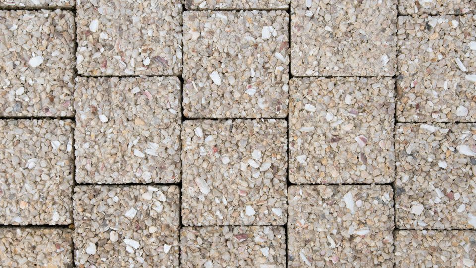 An experimental sidewalk in the Olympic village was built with seashells, which are supposed to absorb water that evaporates in the heat to keep passers-by cool. - Joshua Berlinger/CNN