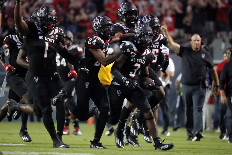 North Carolina State players celebrate an interception by Aydan White (3) during the first half of an NCAA college football game against Louisiana Tech in Raleigh, N.C., Saturday, Oct. 2, 2021. (AP Photo/Karl B DeBlaker)