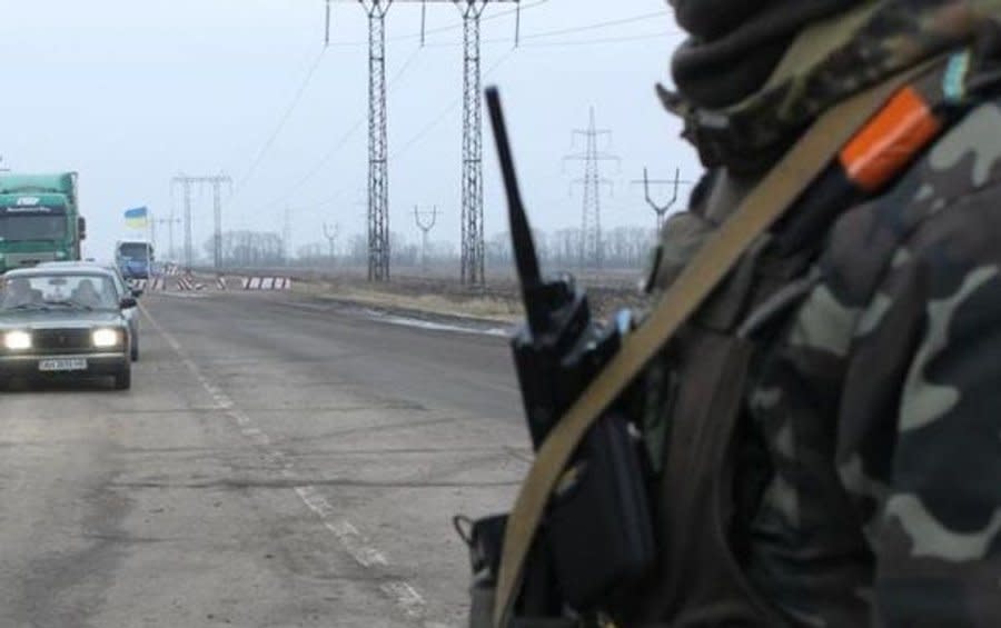 An officer of the Ukrainian Border Guard stands at a checkpoint