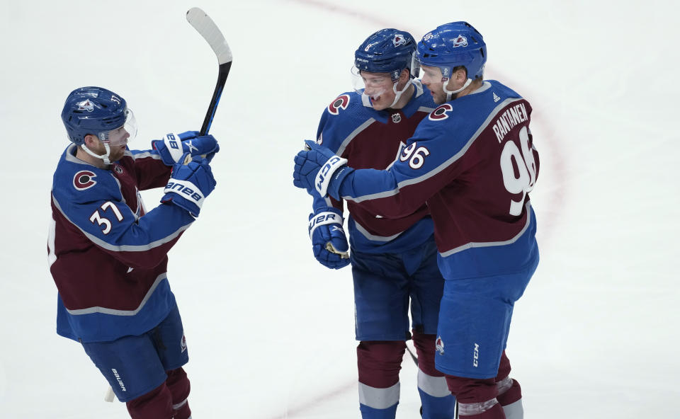 Colorado Avalanche right wing Mikko Rantanen, right, is congratulated, after scoring a goal against the Anaheim Ducks, by defenseman Cale Makar, center, and left wing J.T. Compher during the first period of an NHL hockey game Thursday, Jan. 26, 2023, in Denver. (AP Photo/David Zalubowski)