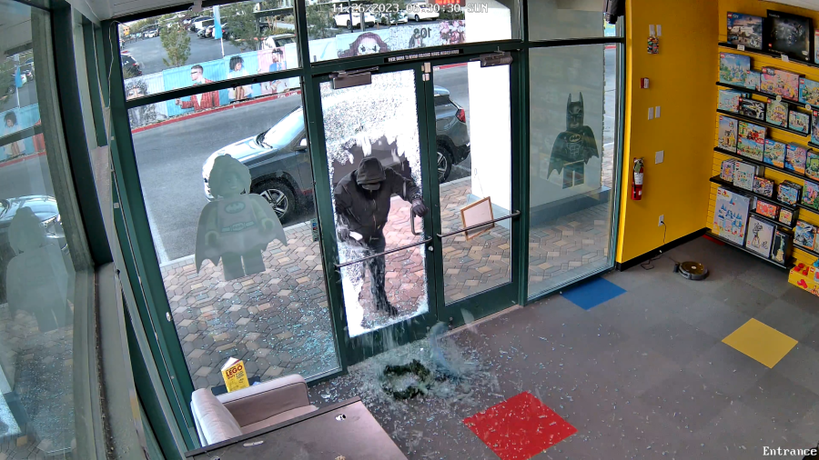 <em>Security footage from early Sunday morning captures a person break the front door of Bricks and Minifigs before scavenging throughout the store. (Edgar Garcia)</em>