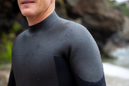 Tom Kay, founder of sustainable outdoor wear brand Finisterre, tests the prototype, of what they believe is the world's first recyclable wetsuit, in Cornwall