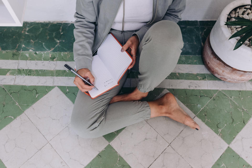 A woman is writing in her diary