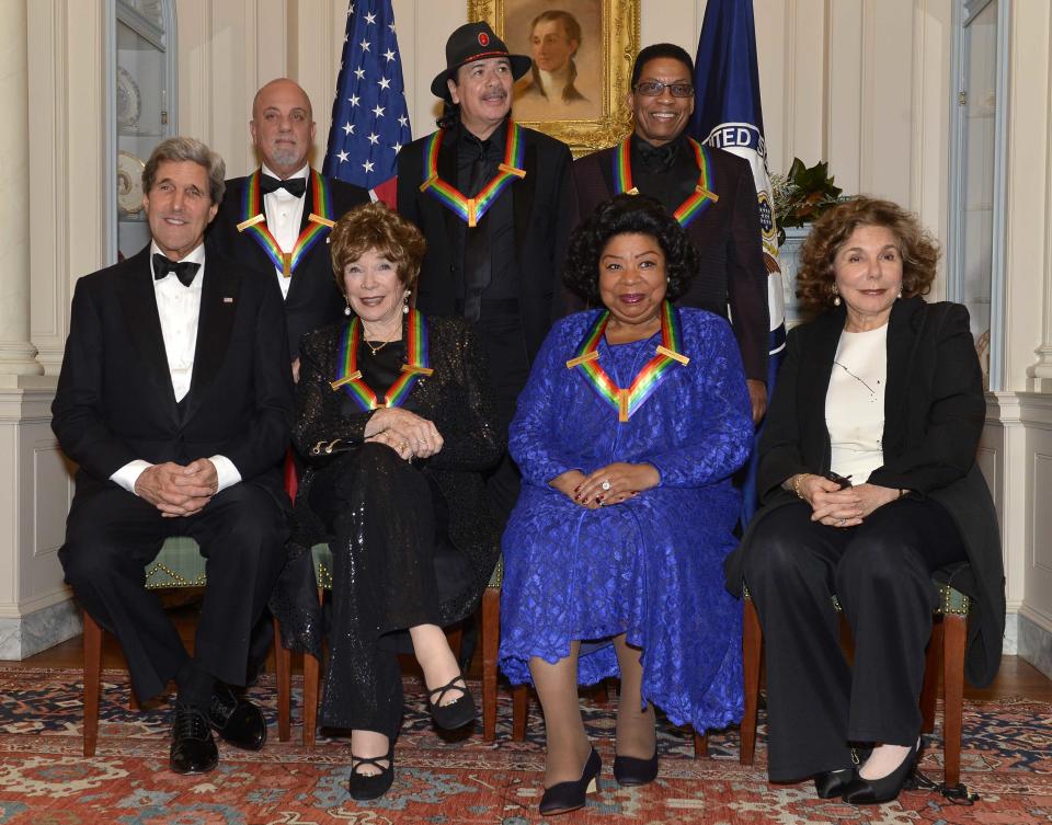U.S. Secretary of State Kerry and his wife pose with Kennedy Center Honorees after a gala dinner at the U.S. State Department in Washington