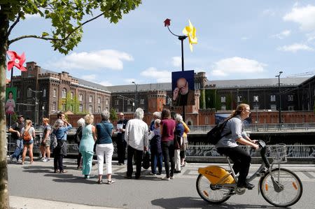 Tourists visit the Brussels district of Molenbeek during a guided tour showing off the area's manufacturing heritage, diverse population and lively market, Belgium, August 13, 2016. REUTERS/Francois Lenoir FOR EDITORIAL USE ONLY. NO RESALES. NO ARCHIVES.