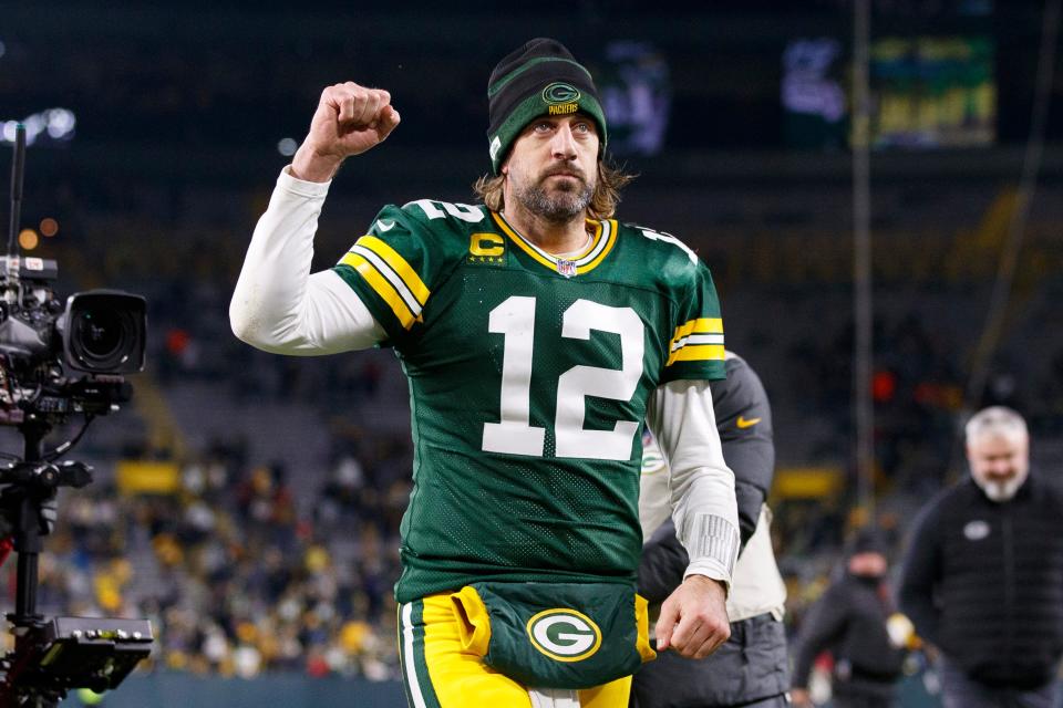 Green Bay Packers quarterback Aaron Rodgers (12) celebrates as he walks off the field following the game against the Chicago Bears at Lambeau Field.