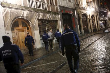 Belgian police officers arrest a man during a continued high level security situation following the recent deadly Paris attacks, in Brussels, Belgium, November 22, 2015. REUTERS/Youssef Boudlal