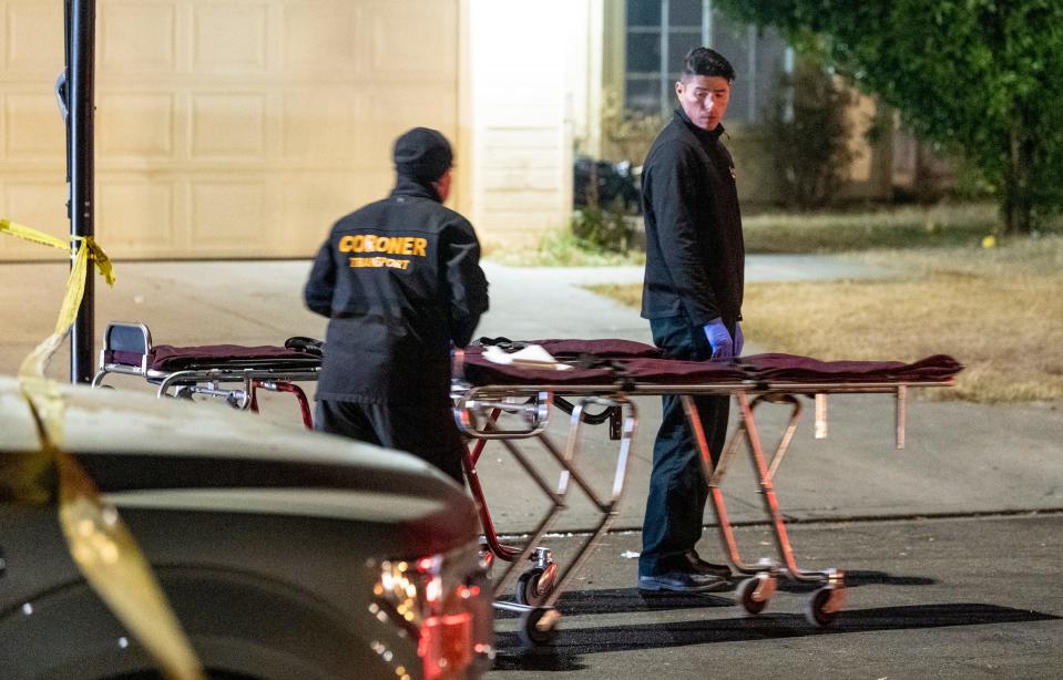 Coroners prepare to remove the bodies of shooting victims as Fresno police investigate a shooting on Nov. 18, 2019.