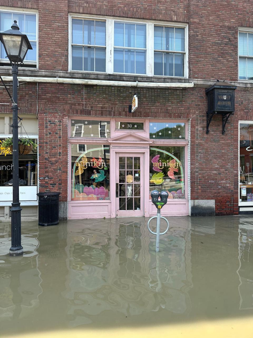 Flooded storefronts are seen in downtown Montpelier on July 11, 2023.