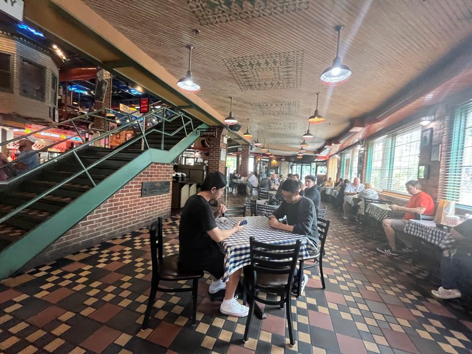 The interior of a Portillo's with a checkered floor and seating.