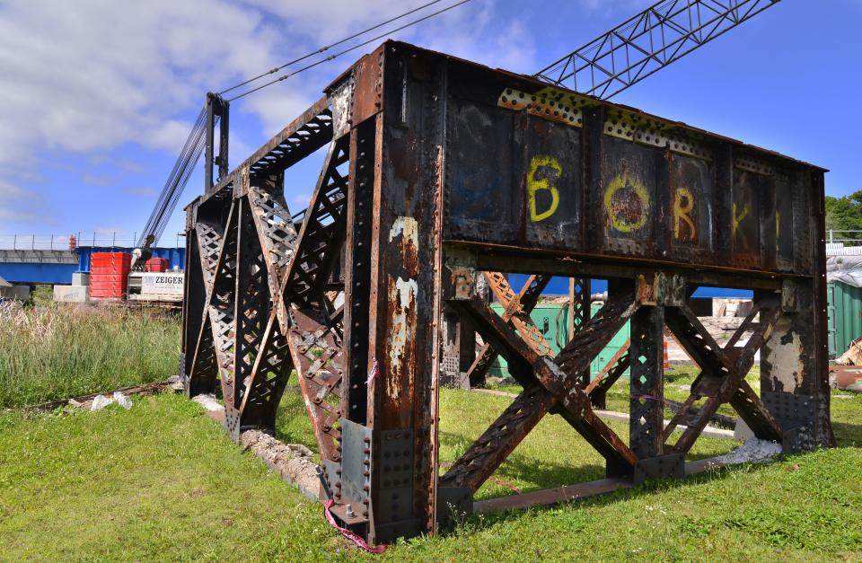 A rusting old steel trestle support for the aging Crane Creek railroad bridge sits on the grass next to Crane Creek in April.