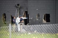 <p>Police officials investigate the back of the Pulse nightclub after a shooting involving multiple fatalities at the nightclub in Orlando, Fla., June 12, 2016. (AP Photo/Phelan M. Ebenhack) </p>