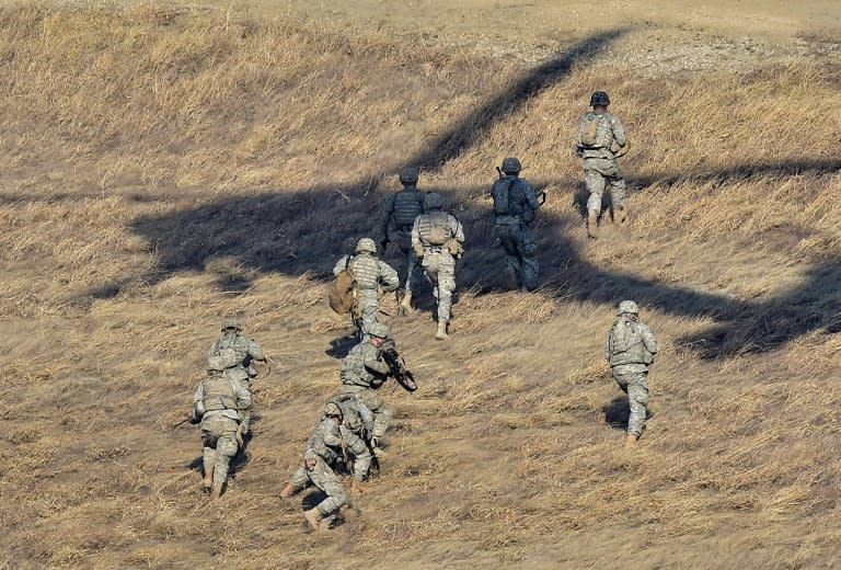 US soldiers move from their drop-off point after exiting a US Army UH-60 Black Hawk helicopter during a live-fire drill in Pocheon, north of Seoul, in March 2015